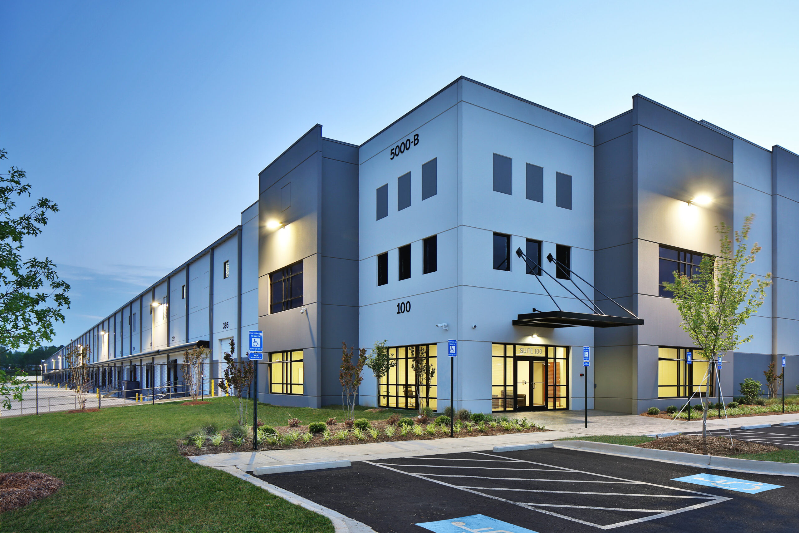 Modern distribution warehouse building entrance at night ggelectricservice